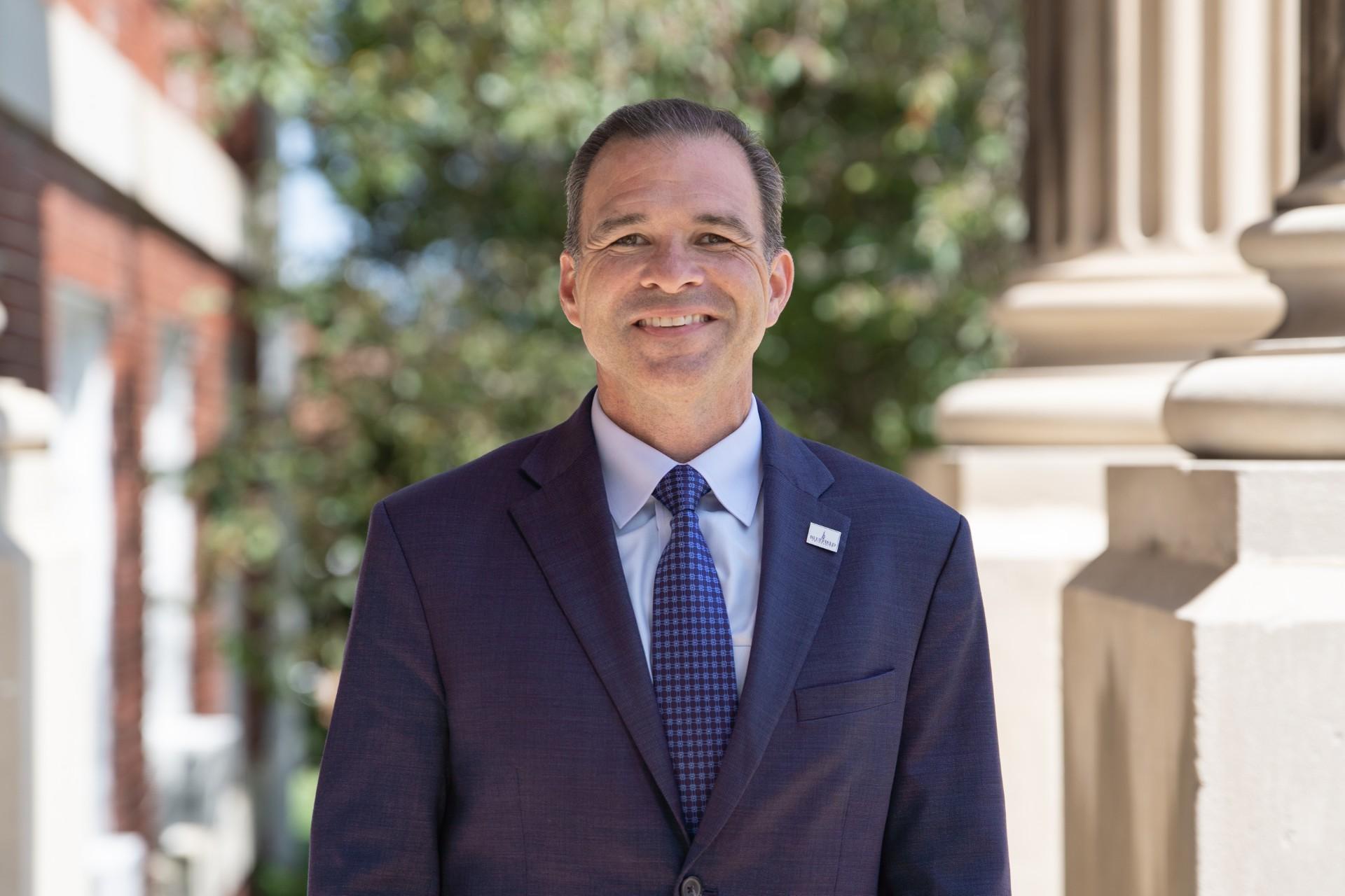 Dr. Steven Peterson in front of Lansdell Hall.