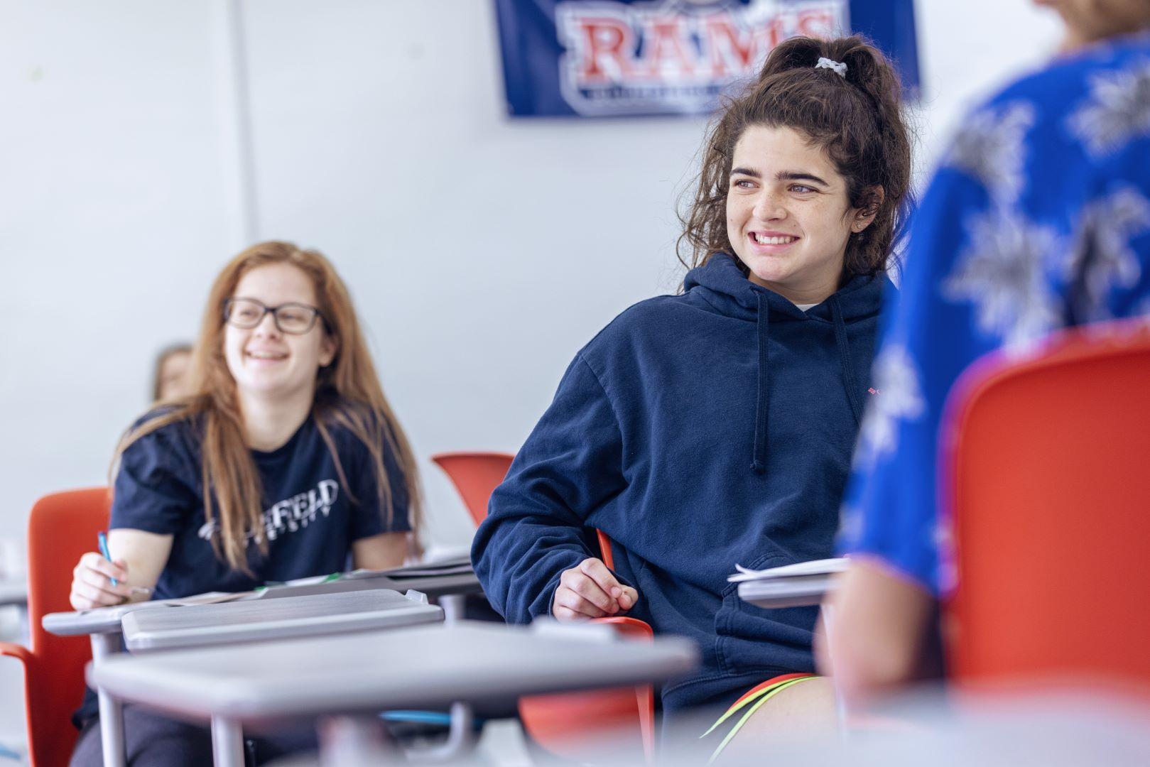 Two female students in a classroom